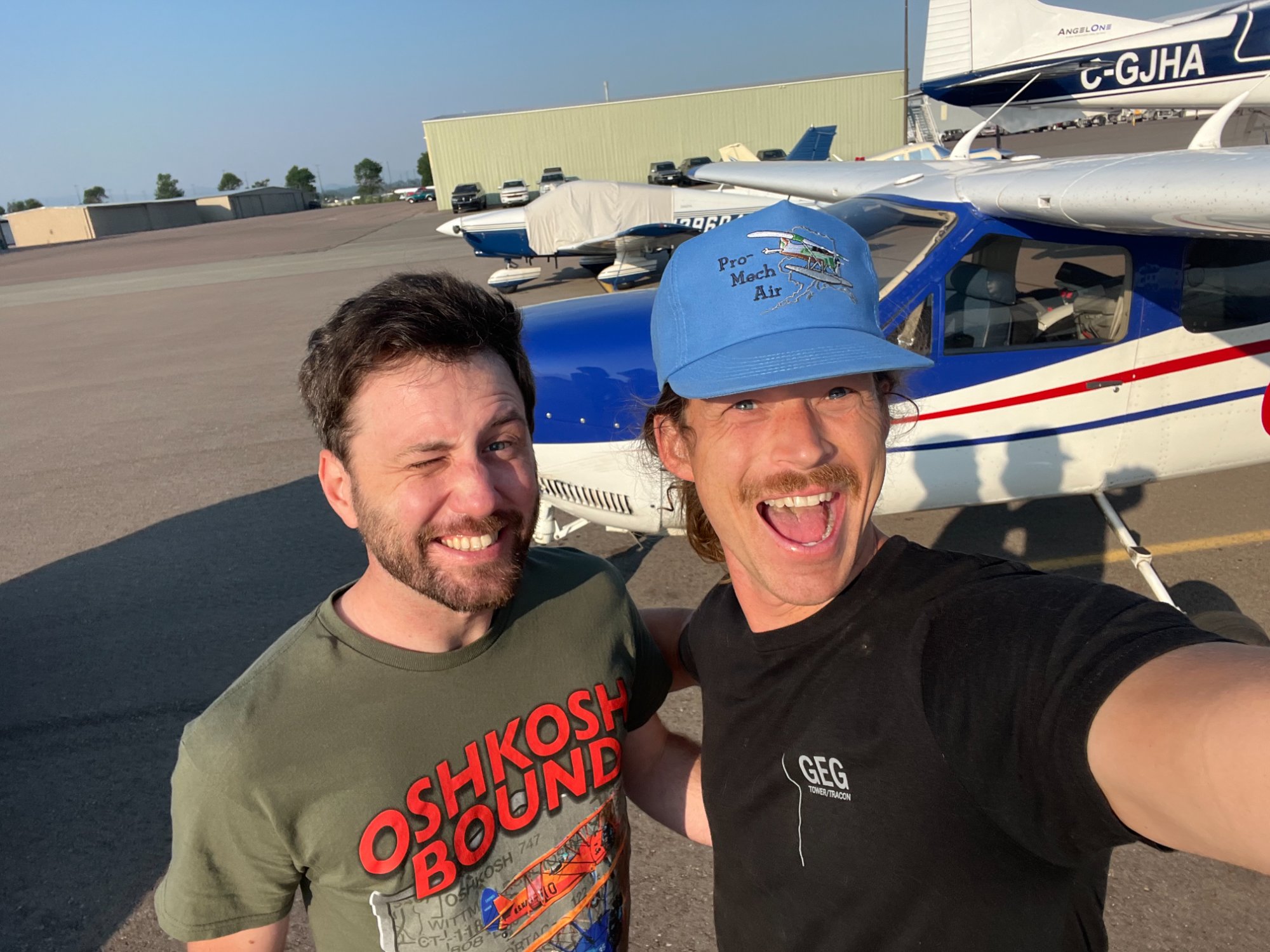 Two pilots at airport with Cessna